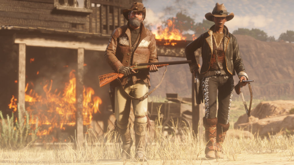 Two bounty hunters in front of burning building.